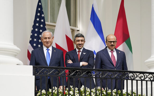 Then-prime minister Benjamin Netanyahu, United Arab Emirates Foreign Minister Abdullah bin Zayed al-Nahyan, and Bahrain Foreign Minister Khalid bin Ahmed Al Khalifa, stand on the Blue Room Balcony during the Abraham Accords signing ceremony on the South Lawn of the White House on September 15, 2020, in Washington. (AP Photo/Alex Brandon)