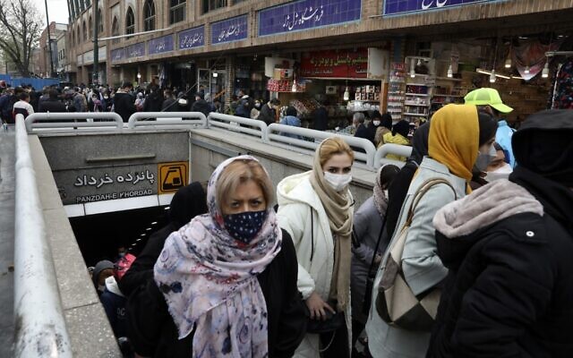 Mask-clad commuters leave a metro station at Tehran's Grand Bazaar, ahead of the Persian New Year, or Nowruz, in Iran, Monday, March 15, 2021. (AP Photo/Vahid Salemi)