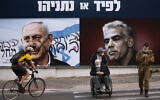 An election campaign billboard for the Likud party that shows a portrait of its leader Benjamin Netanyahu, left, and Yesh Atid head Yair Lapid in Ramat Gan, March 21, 2021. (AP Photo/Oded Balilty)