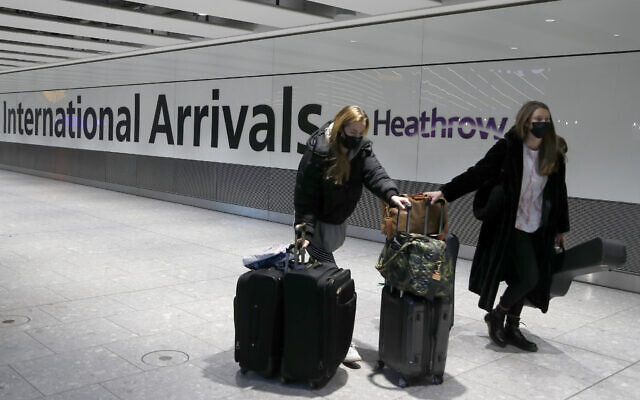 Illustrative photo of travelers arriving at Heathrow Airport in London, January 17, 2021. (AP Photo/Frank Augstein, File)