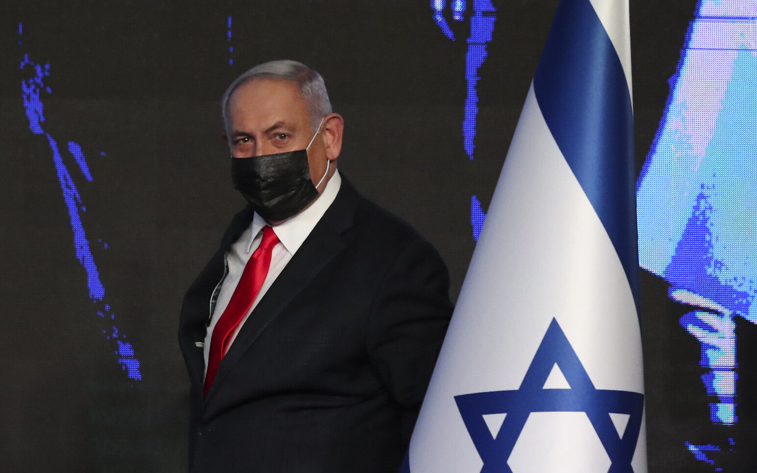 Prime Minister Benjamin Netanyahu arrives to address supporters after the March 23 elections, at his Likud party's election HQ in Jerusalem, early on Wednesday, March. 24, 2021. (AP Photo/Ariel Schalit)
