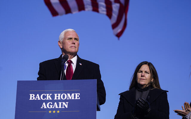 FILE - In this Jan. 20, 2021, file phot, former Vice President Mike Pence speaks after arriving back in his hometown of Columbus, Ind., as his wife Karen watches. (AP Photo/Michael Conroy, File)