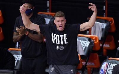 Miami Heat's Meyers Leonard (0) cheers on the team from the sideline during the second half of an NBA conference final playoff basketball game against the Boston Celtics on September 19, 2020, in Lake Buena Vista, Florida. (AP Photo/Mark J. Terrill)