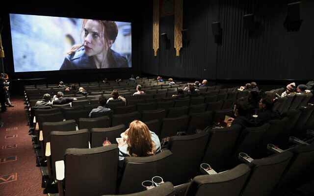 Moviegoers sitting in a socially distant seating arrangement at the AMC Lincoln Square 13 theater on the first day of reopened theaters after being closed due to the COVID-19 pandemic, March 5, 2021, in New York. (Evan Agostini/Invision/AP)
