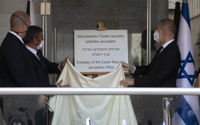 Czech Prime Minister Andrej Babis, right, Israeli Foreign Minister Gabi Ashkenazi, center left, and Israeli Public Security Minister Amir Ohana unveil a sign during a ceremony at the new Embassy of the Czech Republic Jerusalem office in Jerusalem on March 11, 2021. (AP Photo/Sebastian Scheiner, Pool)