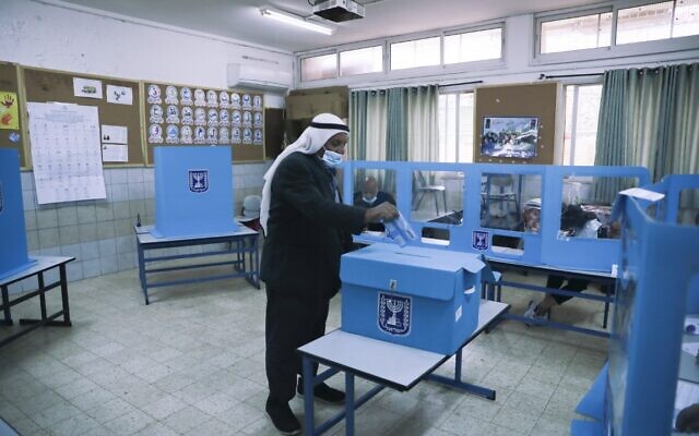 An Arab Israeli man votes at a polling station in Maghar, March. 23, 2021. (AP Photo/ Mahmoud Illean)