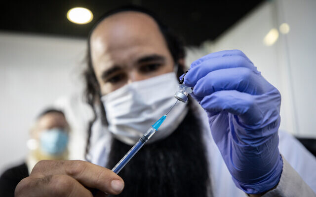 Illustrative: A medical worker prepares a COVID-19 vaccine at a Clalit vaccination center in Jerusalem on February 25, 2021. (Olivier Fitoussi/Flash90)
