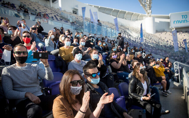 Israeli Green Pass holders enjoy singer Ivri Lider at a concert organized by the Tel Aviv municipality, at Bloomfield Stadium, March 5, 2021. (Miriam Alster/FLASH90)