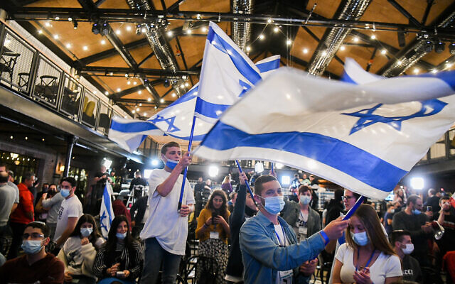 Yamina supporters at the party headquarters in Petah Tikva, on election night, on March 23, 2021. (Avi Dishi/Flash90)