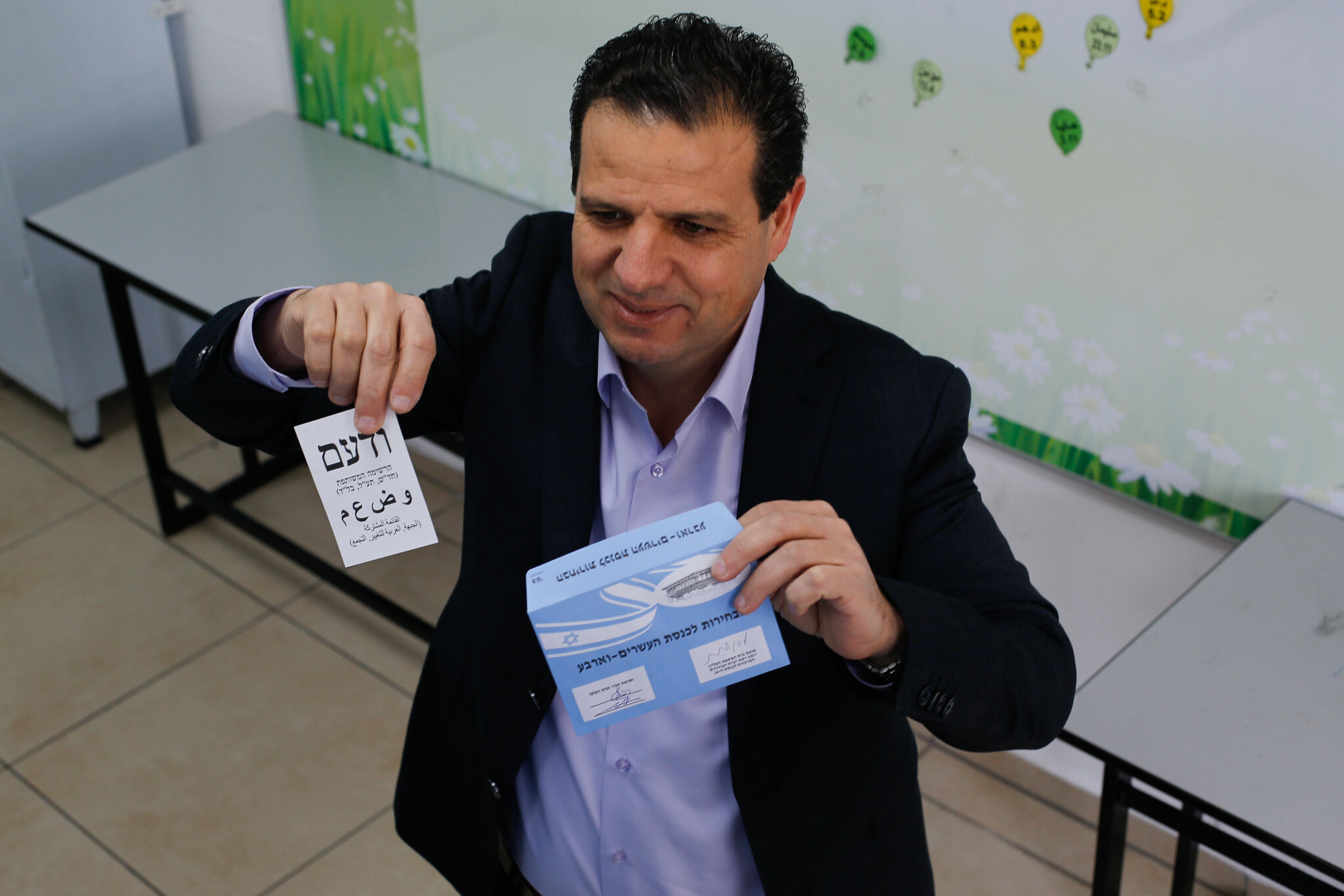 Joint List party leader Ayman Odeh casts his ballot at a voting station in Haifa during the Knesset elections, March 23, 2021. (Jamal Awad/Flash90)