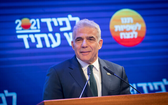 Yesh Atid party leader Yair Lapid speaks at party headquarters in Tel Aviv, on election night, March 23, 2021. (Miriam Alster/Flash90)