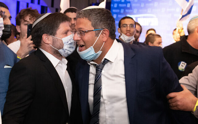 Head of the far-right Religious Zionism party MK Bezalel Smotrich and party member Itamar Ben Gvir with supporters at the party headquarters in Modi'in, on election night, March 23, 2021. (Sraya Diamant/Flash90)
