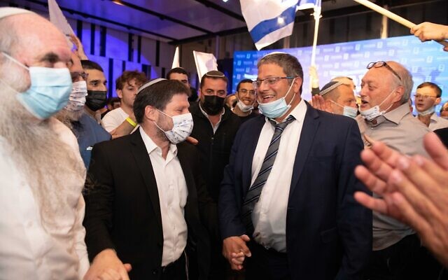 Religious Zionism party chairman Bezalel Smotrich (L) and candidate Itamar Ben Gvir celebrate at the party headquarters in Modi'in on election night, March 23, 2021. (Sraya Diamant/Flash90)