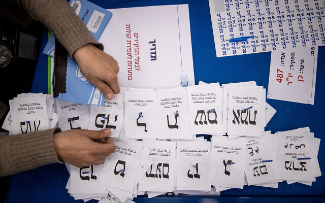 FILE: Central Election Committee workers count the remaining ballots at the Israeli parliament in Jerusalem, after the general elections, on March 25, 2020. (Yonatan Sindel/Flash90)