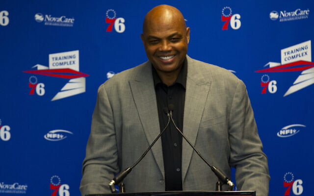 Charles Barkley speaks at the podium prior to his sculpture being unveiled at the Philadelphia 76ers training facility in Camden, New Jersey, Sept. 13, 2019. (Mitchell Leff/Getty Images via JTA)
