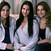 In this Nov. 5, 2019, photo, from left, Guila, Macy and Zoya Fakhoury, three of Amer Fakhoury's four daughters, gather in Salem, New Hampshire. Amer Fakhoury, a US citizen, went to visit family in his native Lebanon in September after a 20-year absence, and was jailed there by authorities. (AP Photo/Kathy McCormack)