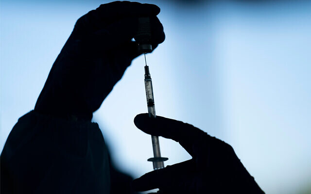 A medical worker prepares the Pfizer-BioNTech COVID-19 vaccine at Tudor Ranch in Mecca, California, January 21, 2021. (AP Photo/Jae C. Hong, File)