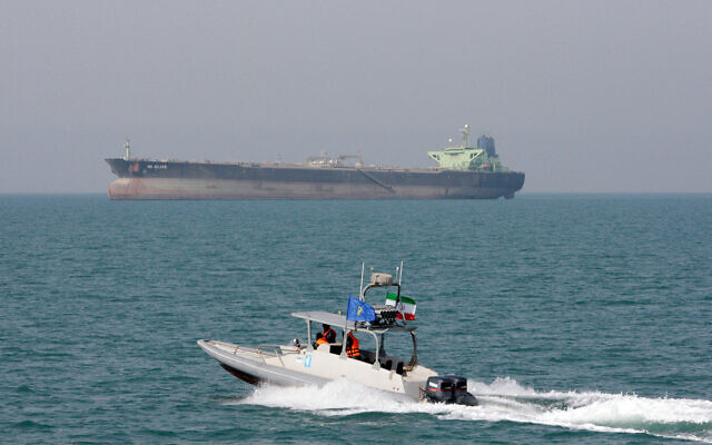 Illustrative: An Iranian Revolutionary Guard speedboat moves in the Persian Gulf while an oil tanker is seen in background, July 2, 2012. (AP Photo/Vahid Salemi, File)