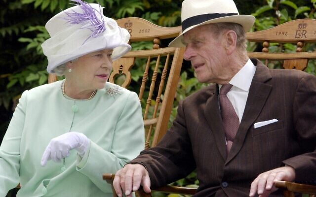 In this file photo taken on July 17, 2002, Britain's Queen Elizabeth II and Britain's Prince Philip, Duke of Edinburgh chat while seated during a musical performance in the Abbey Gardens, Bury St Edmunds, during her Golden Jubilee visit to Suffolk, east of England. (Fiona HANSON / POOL / AFP)