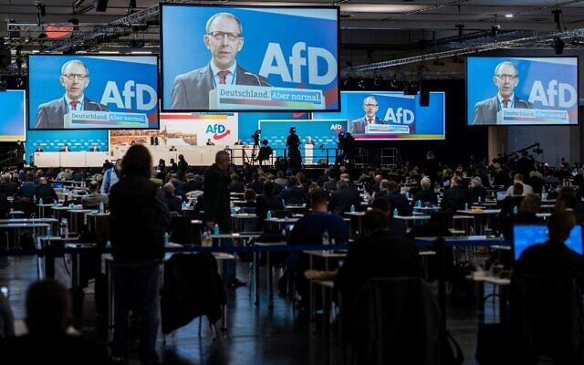 Joerg Urban, leader of the Far-right Alternative for Germany (AfD) in Saxony, is seen on displays as he gestures while addressing delegates during an AfD party congress in Dresden, eastern Germany, on April 10, 2021. (JENS SCHLUETER / AFP)