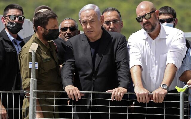 Prime Minister Benjamin Netanyahu and Internal Security Minister Amir Ohana (R)  visit the site of an overnight fatal crush during a religious gathering at Mt. Meron in northern Israel, on April 30, 2021. (Ronen ZVULUN / POOL / AFP)