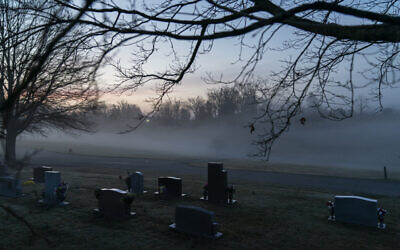 In this Wednesday, March 17, 2021 file photo, morning fog blankets a cemetery in West Virginia. The number of U.S. suicides fell nearly 6% in 2020 amid the coronavirus pandemic — the largest annual decline in at least four decades, according to preliminary government data. (AP Photo/David Goldman)