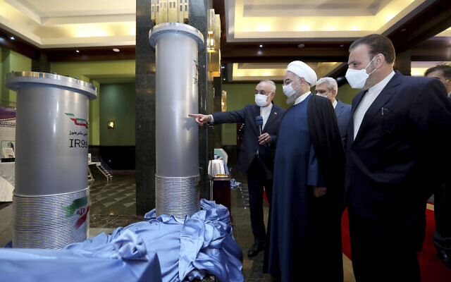 President Hassan Rouhani, second right, is shown new centrifuges and listens to head of the Atomic Energy Organization of Iran Ali Akbar Salehi, while visiting an exhibition of Iran's new nuclear achievements in Tehran, Iran, April 10, 2021. (Iranian Presidency Office via AP)