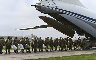 Russian paratroopers load into a plane for airborne drills during maneuvers in Taganrog, Russia, April 22, 2021. (AP Photo)