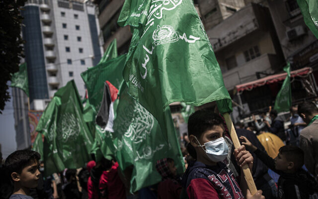 Palestinians holding Hamas movement green flags attend a protest in solidarity with Muslim worshipers in Jerusalem, in Gaza City, April 23, 2021. (AP Photo/Khalil Hamra)