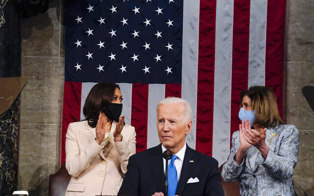 US Vice President Kamala Harris and House Speaker Nancy Pelosi look at each other as US President Joe Biden addresses a joint session of Congress, April 28, 2021, in the House Chamber at the US Capitol in Washington. (Melina Mara/The Washington Post via AP, Pool)