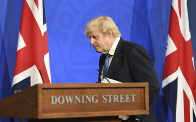 Britain's Prime Minister Boris Johnson leaves after a coronavirus briefing in Downing Street, London, April 5, 2021. (Stefan Rousseau/Pool via AP)