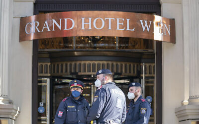 Police officers stay in front of the ‘Grand Hotel Wien’ in Vienna, Austria, April 9, 2021, where closed-door nuclear talks with Iran take place. (AP Photo/Florian Schroetter)