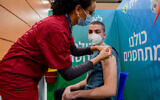 Illustrative: An Israeli student receives a COVID-19 vaccine injection at a Leumit vaccination center in Tel Aviv, on January 23, 2021, just after the country rolled out inoculation to everyone aged 16-plus. (Avshalom Sassoni/Flash90)