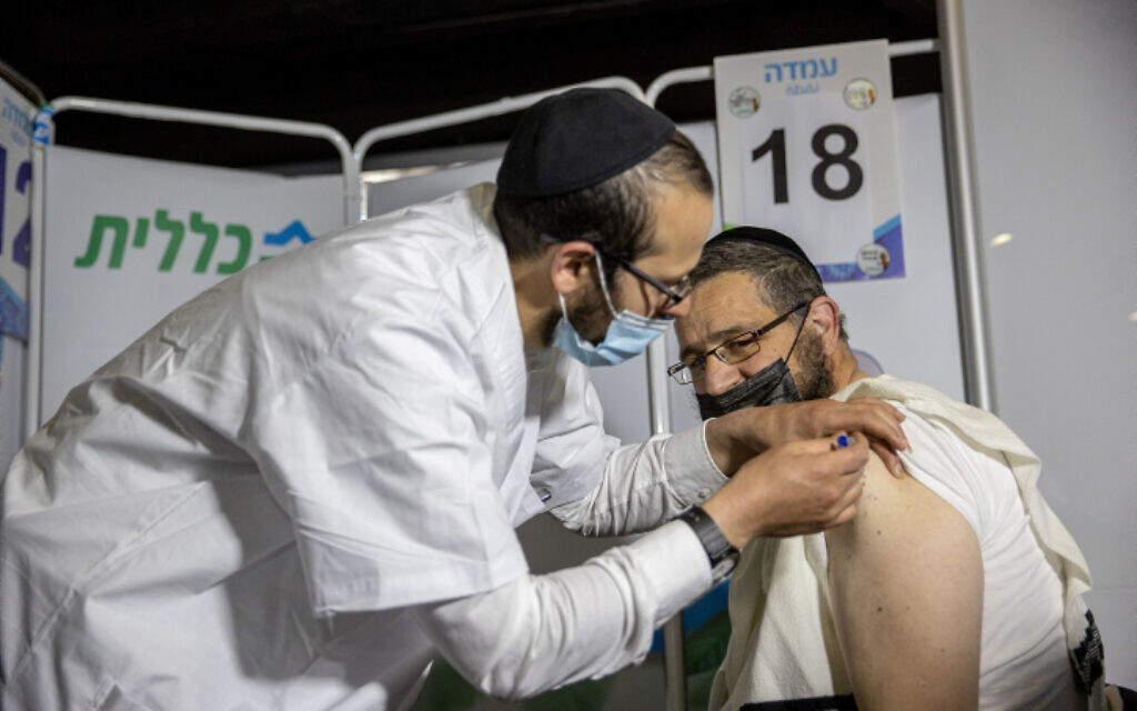 Illustrative image: a Haredi man receives a coronavirus vaccine in Jerusalem, on March 11, 2021. (Yonatan Sindel/Flash90)