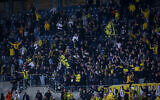 Soccer fans at a game between Beitar Jerusalem FC and Ashdod FC, at Teddy Stadium, in Jerusalem, on March 17, 2021. (Flash90)