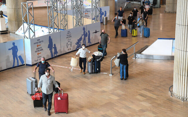 Travelers walk to a coronavirus testing area after arriving at Ben Gurion Airport on March 8, 2021. (Flash90)