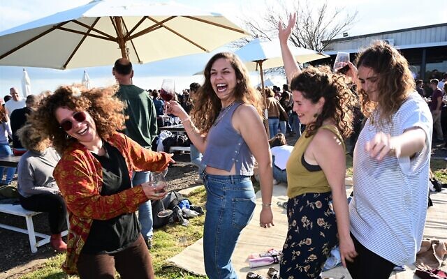 Illustrative: Israelis at a No-Masks outdoor dance party for COVID-19 vaccinated guests only, at the Tel Shifon Winery, in Kibbutz Ortal, northern Golan Heights, March 19, 2021. (Michael Giladi/Flash90)