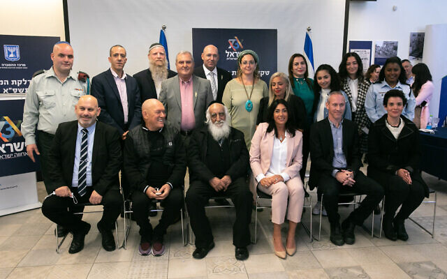 Culture Minister Chili Tropper (2rd R, front) and Miri Regev (3rd R, front), pose for a photo with the torch lighters of the Israeli 73th Independence Day Ceremony at Mount Herzl in Jerusalem, on April 12, 2021 (Olivier Fitoussi/Flash90)