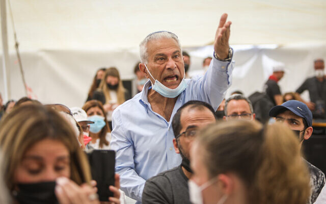 A man reacts during a speech of Prime Minister Benjamin Netanyahu at a state memorial ceremony for victims of terror, at Mount Herzl military cemetery in Jerusalem, April 14, 2021. (Noam Revkin Fenton/Flash90)