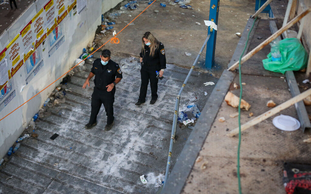 Israeli rescue forces and police on a metal-floored walkway hours after a mass fatality event during the celebrations of the Jewish holiday of Lag B'Omer on Mt. Meron, in northern Israel on April 30, 2021. (David Cohen/Flash90)