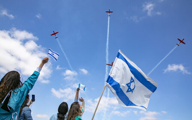Israeli medical staff cheer an Israeli airforce aerobatic team as they fly over Shaarei Tsedek hospital in Jerusalem on Israel's 72nd Inependence Day, April 29, 2020. (Olivier Fitoussi/Flash90)