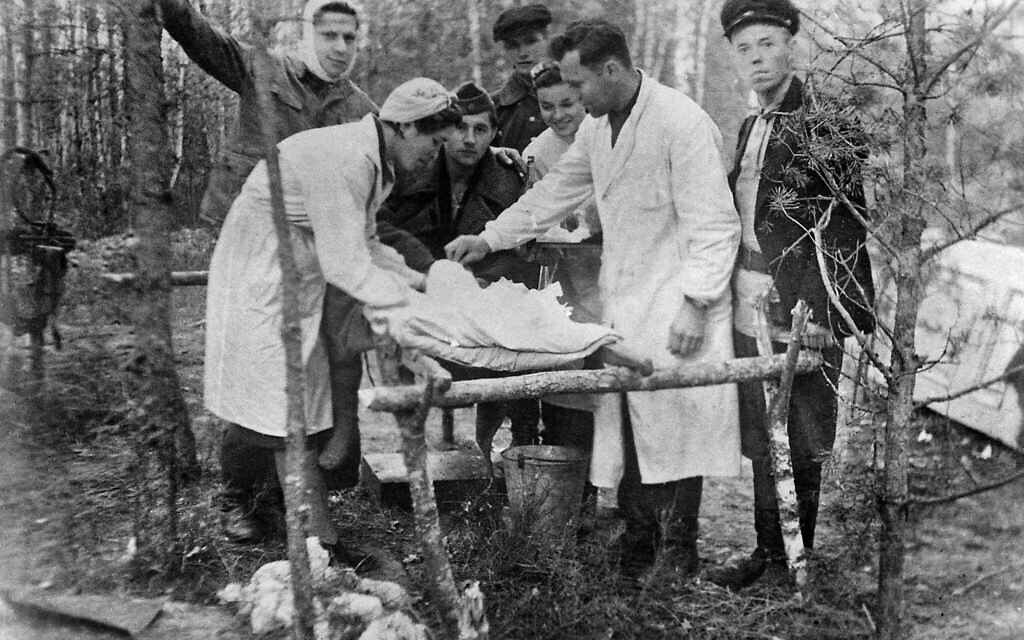 Faye Schulman assisting at an operation for a wounded partisan. (United States Holocaust Memorial Museum, courtesy of Belarusian State Museum of the History of the Great Patriotic War)