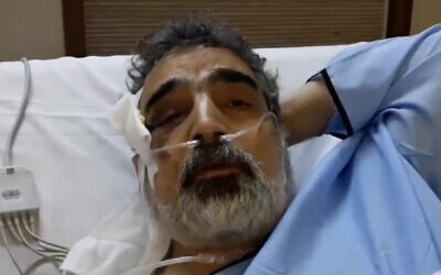 Behrouz Kamalvandi, spokesman for the Atomic Energy Organization of Iran, is interviewed from his hospital bed on April 12, 2021, after being injured the day before in a reported fall at the Natanz nuclear facility. (Screen capture: Twitter)