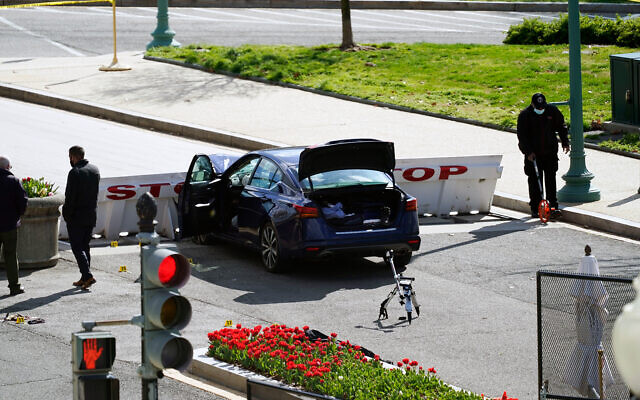 Authorities investigate at the scene where a car crashed into a barrier on Capitol Hill in Washington, April 2, 2021. (AP Photo/Alex Brandon)