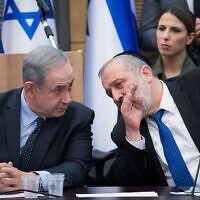 Prime Minister Benjamin Netanyahu (left) speaks with Shas party chairman Aryeh Deri during a meeting in Jerusalem, March 4, 2020. (Yonatan Sindel/Flash90)
