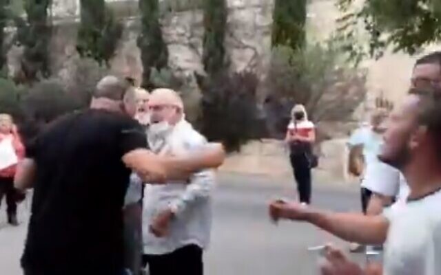 Left: A pro-Netanyahu supporter who verbally attacked Maria Elkin, wife of New Hope MK Ze'ev Elkin, is seen outside their Jerusalem home on April 19, 2021. (Screen capture: Twitter)