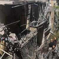 Israelis inspect a damaged house in the Tel Aviv suburb of Givatayim on May 12, 2021, after it was hit by a rocket fired from Palestinian terrorists in the Gaza Strip. (Alexandra Vardi/AFP)