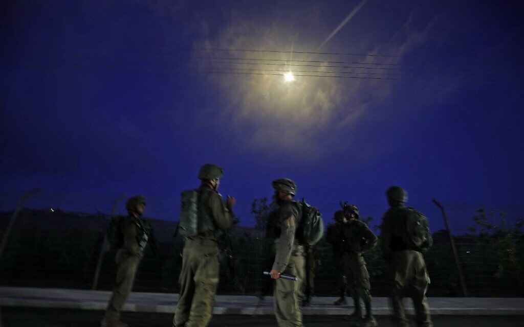 Israeli soldiers stand guard after firing flares above the northern town of Metulla, by the border with Lebanon, following a pro-Palestinian protest across the border in the Lebanese Khiam area, on May 14, 2021 (Jalaa MAREY / AFP)