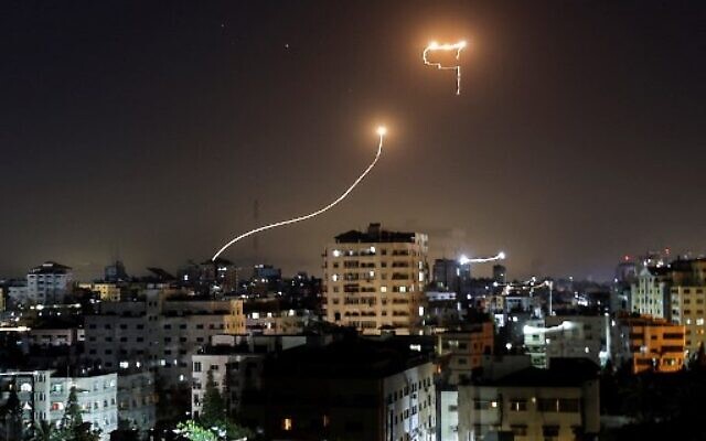 A streak of light appears as Israel’s Iron Dome anti-missile system intercepts rockets launched from the Gaza Strip, on May 16, 2021. (Photo by MAHMUD HAMS / AFP)