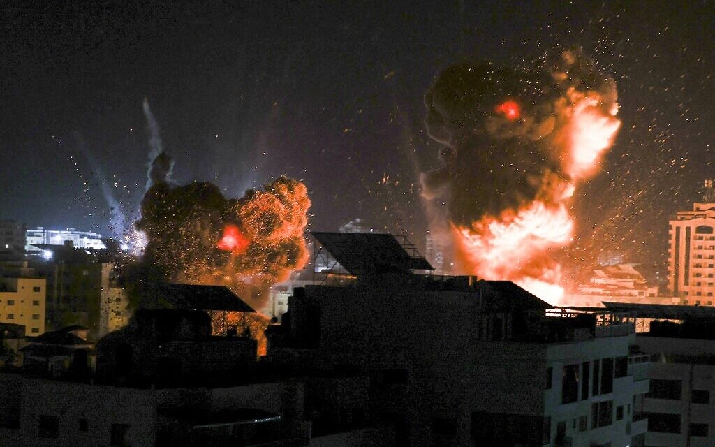 Explosions light-up the night sky above buildings in Gaza City as Israeli forces carry out strikes on the Palestinian enclave, early on May 18, 2021. (MAHMUD HAMS / AFP)